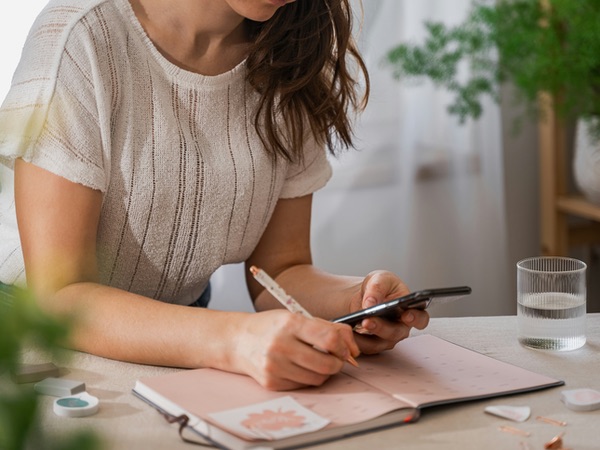 Woman writing a todo list