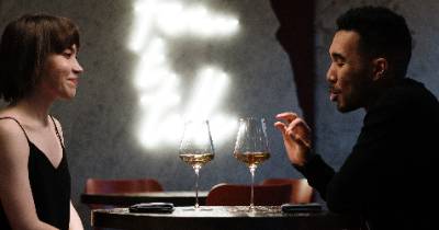 A woman and man sitting at a table talking