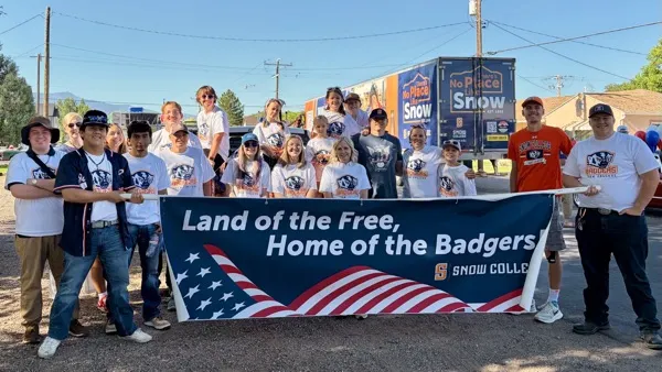 Snow College Badgers holding banner: Land of the Free, Home of the Badgers!